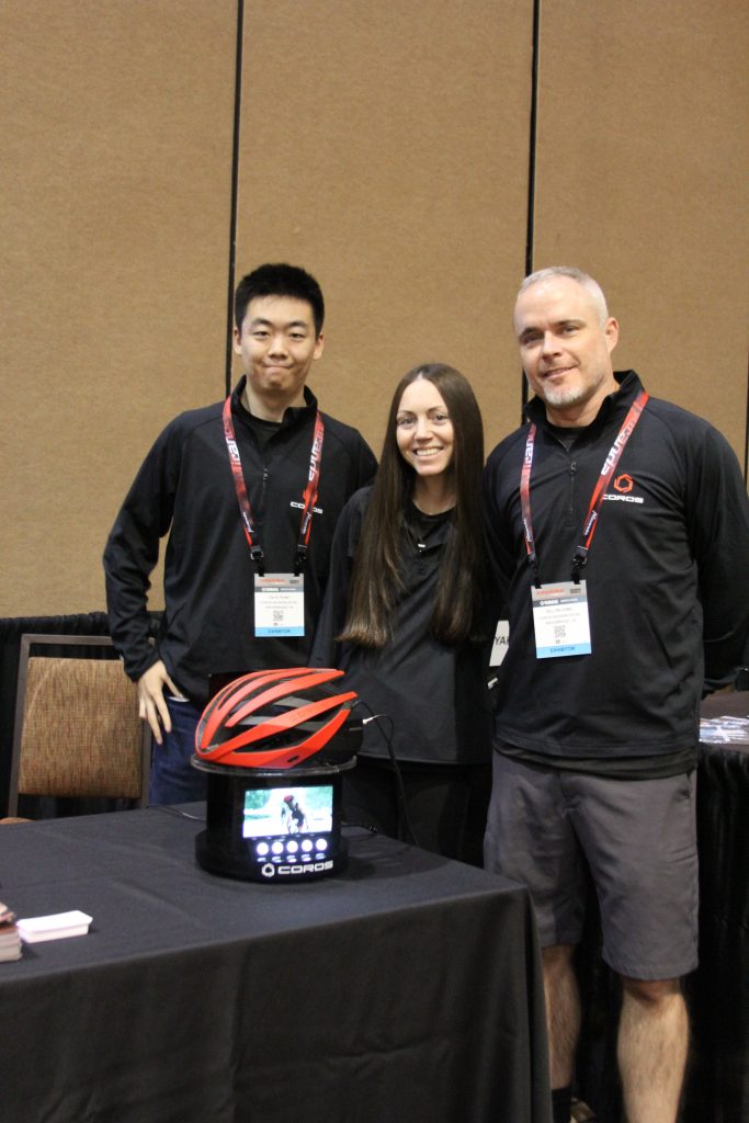 THE COROS CREW SMILING WITH PRIDE SHOWING THEIR BLUETOOTH ROAD HELMET